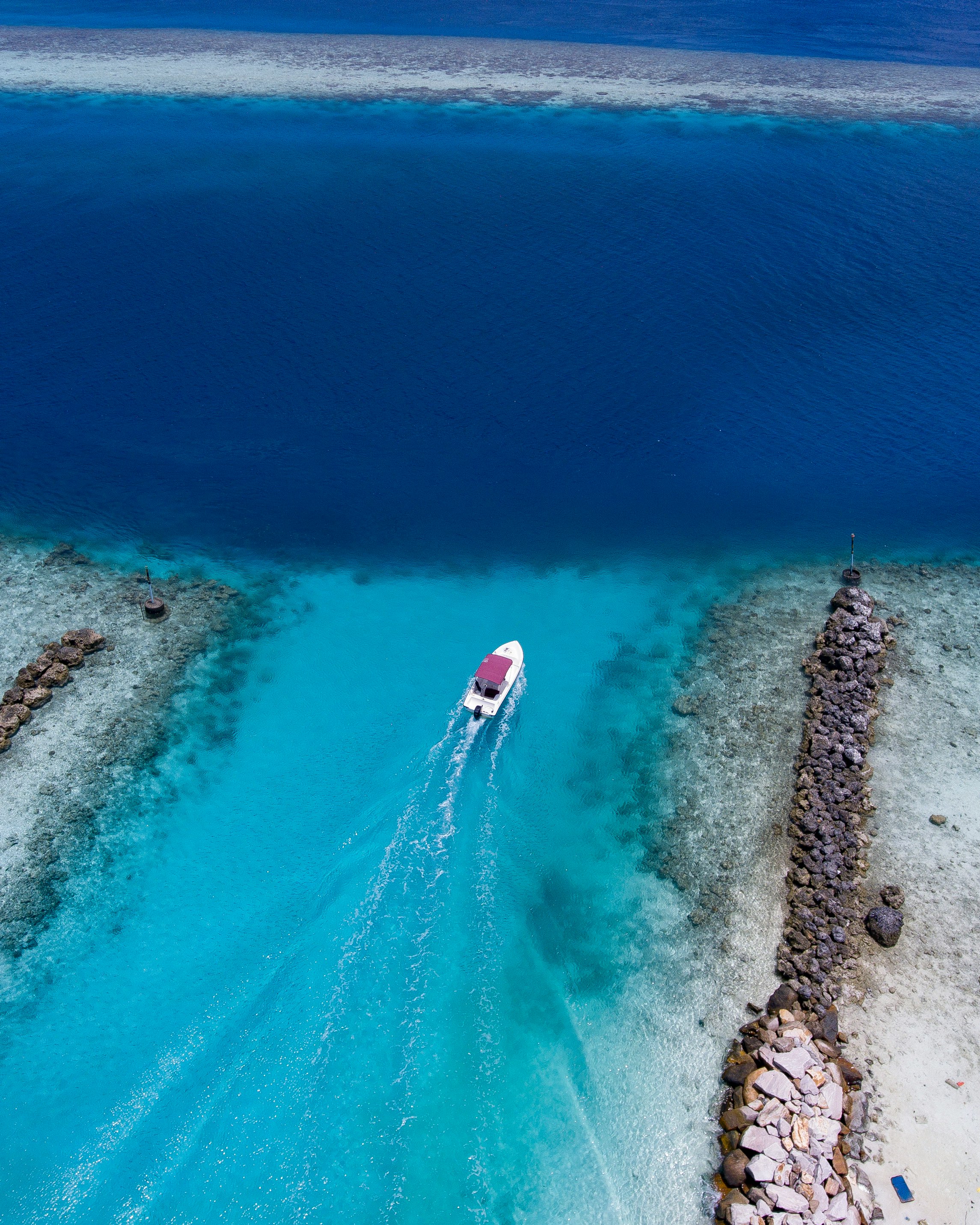 birds eye view of white boat on body of water